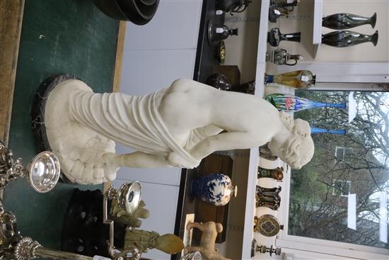 A Victorian style carved white marble figure of a woman pulling on her stocking, H.31in.